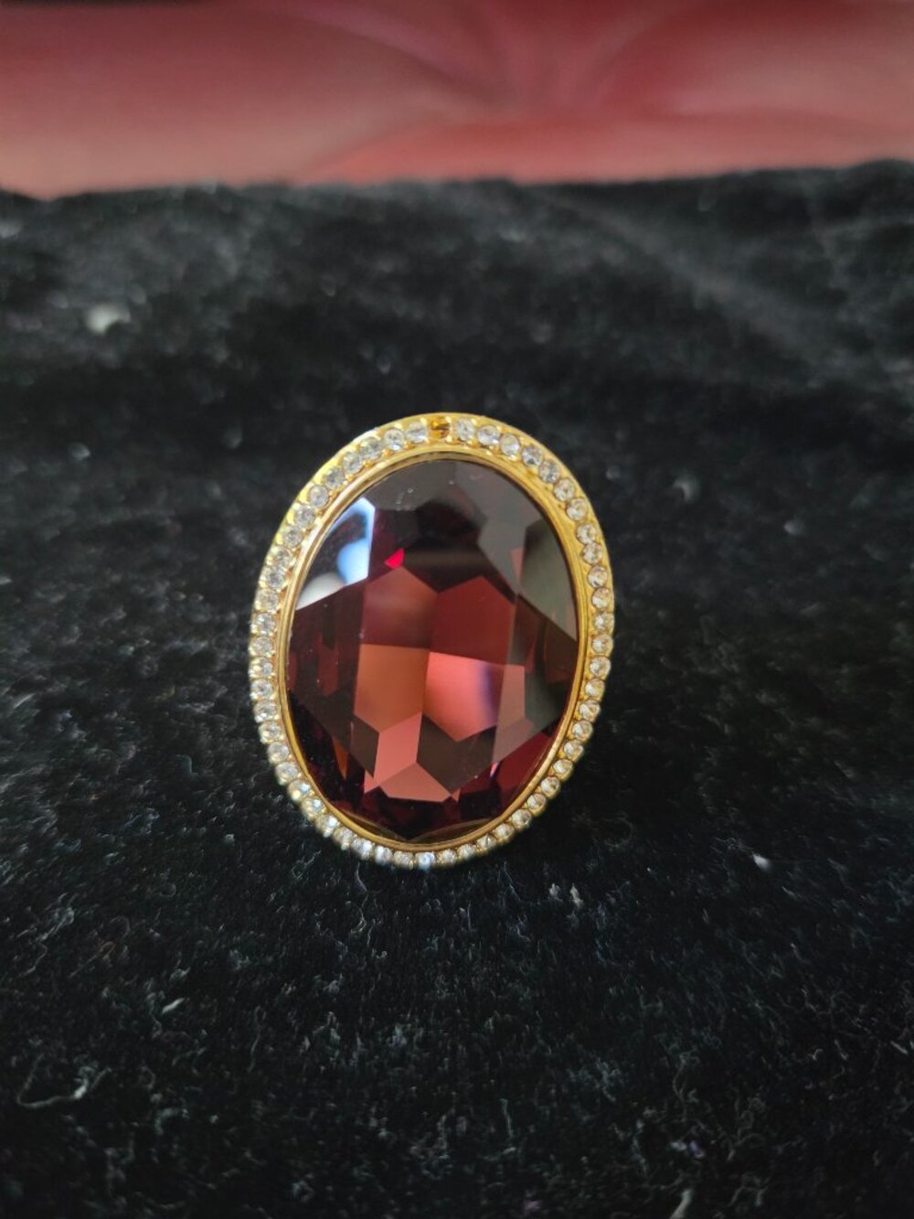 Ring with red stone and stones that resemble diamonds